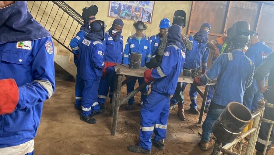 Ifmira welders at an in-house training workshop, working at a bench in coveralls and welding masks